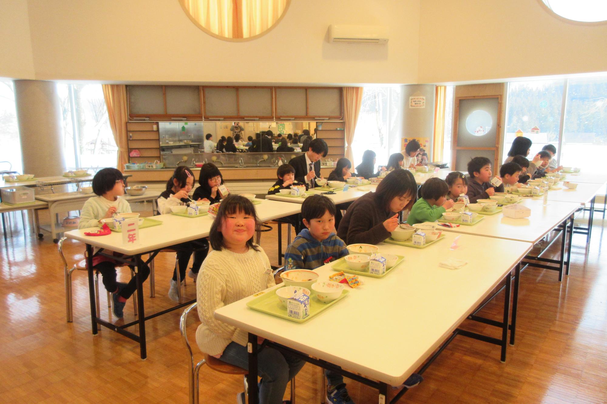 おいしく、楽しく給食を食べて満足気な笑顔を見せる生徒たちの写真