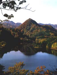 湖面に逆さの山の影が映っている梅花里湖の写真